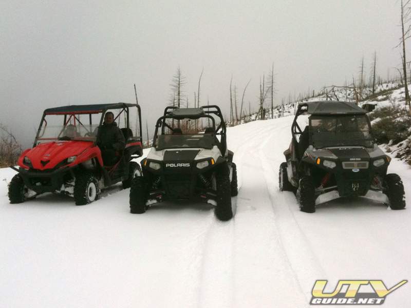 Kawasaki Teryx and two Polaris RZR S in the snow