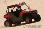 Polaris RZR with paddle tires climbing hill at Patton Valley