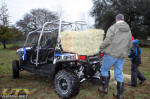Polaris RZR 4 carrying hay in the bed